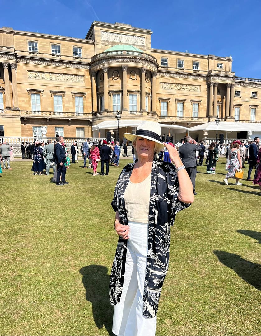 person standing in the buckingham palace garden