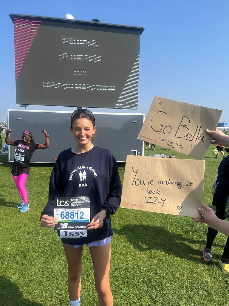 person standing in front of the London marathon sign