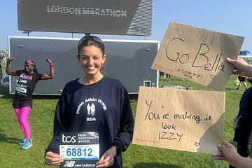 person standing in front of the London marathon sign