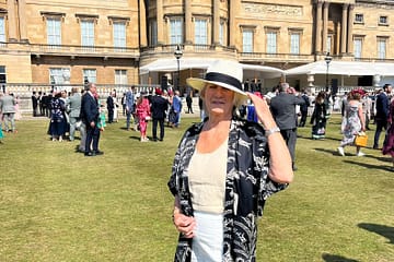 person standing in buckingham palace garden